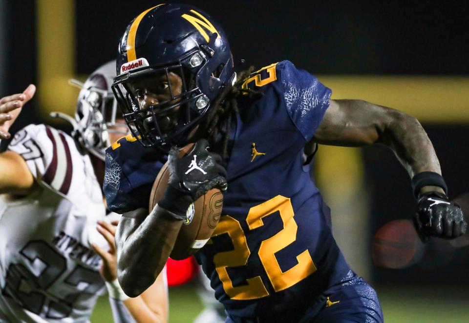 Naples Golden Eagles running back Trayvon Jean (22) runs the ball during the third quarter of the season opener against the Sarasota Riverview Rams at Staver Field in Naples on Friday, Aug. 23, 2024.