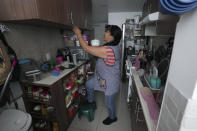 Domestic worker Gabriela Flores puts away dishes at her workplace in Mexico City, Sunday, May 19, 2024. Flores is among approximately 2.5 million Mexicans — largely women — who serve as domestic workers in the Latin American nation. (AP Photo/Marco Ugarte)