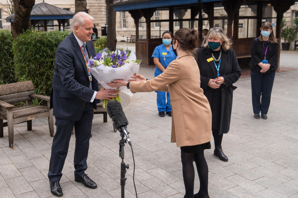 Chief Executive of St Bartholomew's Hospital Professor Charles Knight receives flowers from Queen Elizabeth II during a ceremony at St Bartholomew's Hospital, London on the anniversary of the first national lockdown to prevent the spread of coronavirus. Picture date: Tuesday March 23, 2021. (Photo by Dominic Lipinski/PA Images via Getty Images)