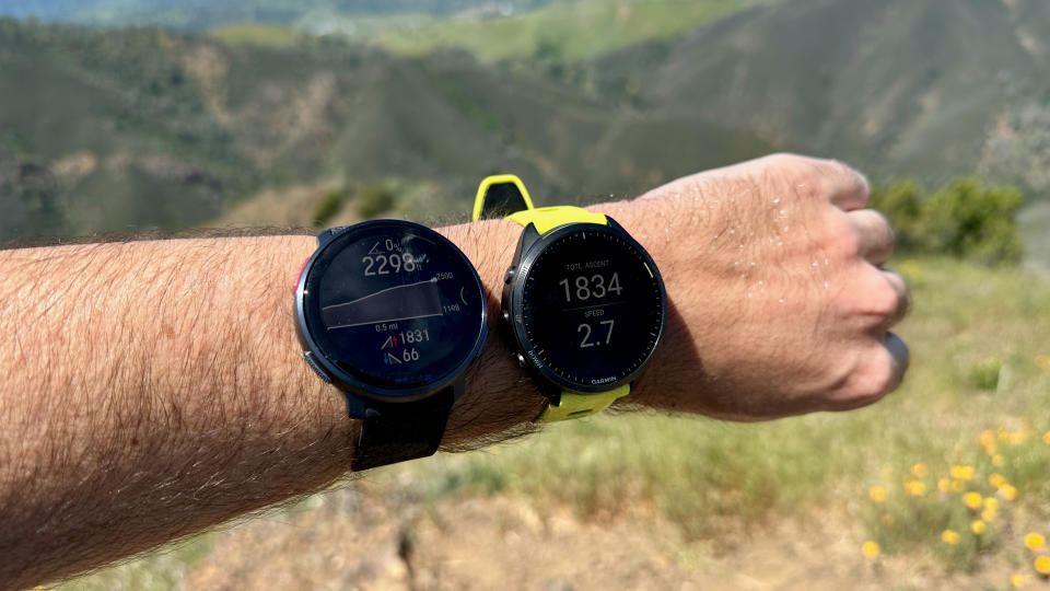 The Garmin Forerunner 965 and Polar Vantage V3 worn on one arm, showing elevation data.