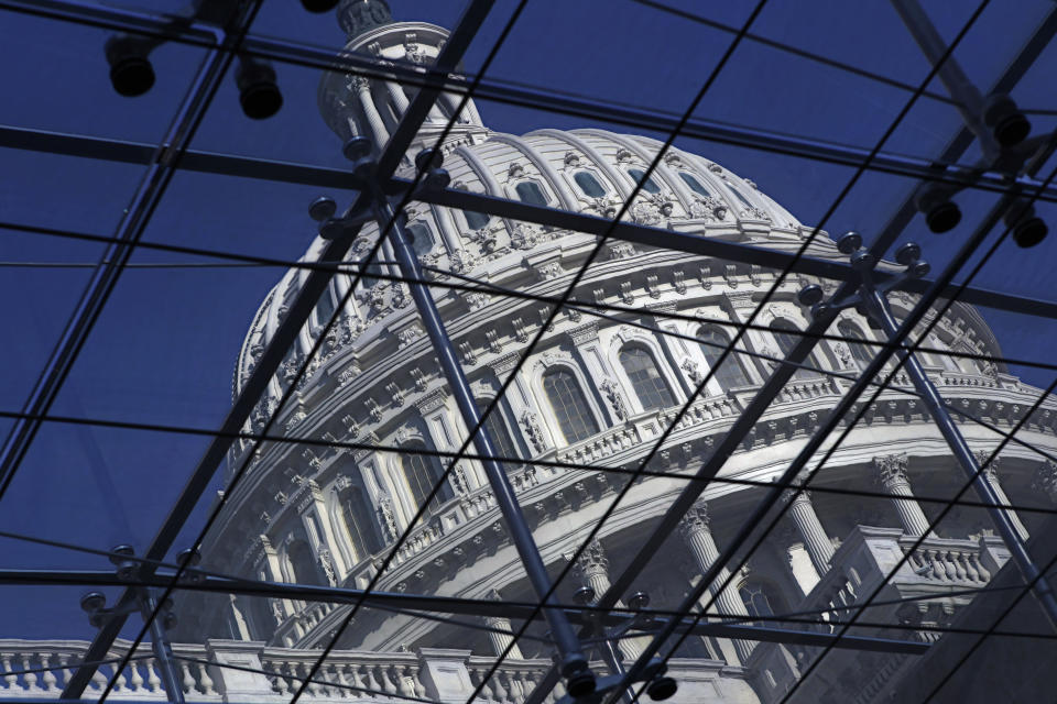 FILE - The Capitol dome on Capitol Hill is seen through a glass structure in Washington, on April 6, 2011. (AP Photo/J. Scott Applewhite, File)