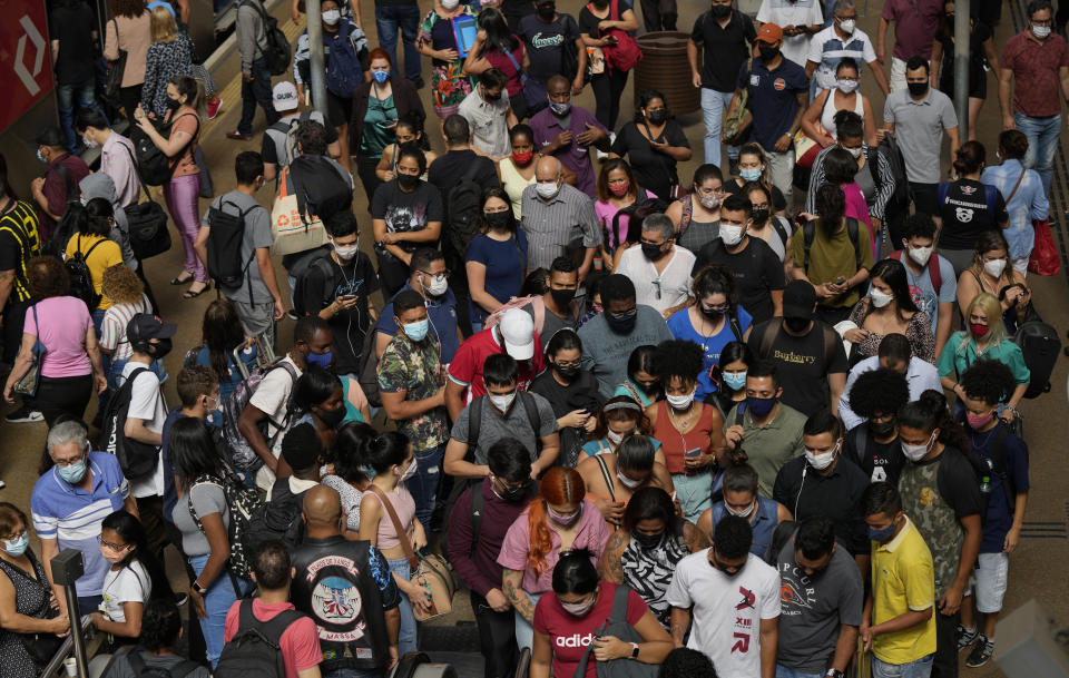 FILE - Commuters wear protective face masks during the COVID-19 pandemic at a subway station in Sao Paulo, Brazil, Dec. 1, 2021. Brazil's government started taking an online public survey on Dec. 24 to inform their decisions about whether and how to vaccinate children against the coronavirus. (AP Photo/Andre Penner, File)