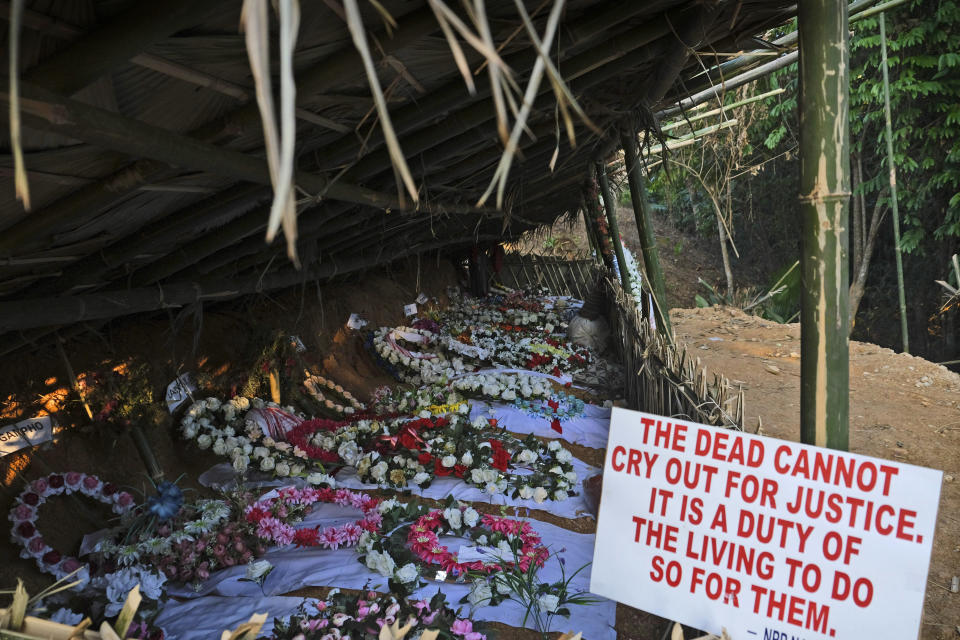 The graves of 12 civilians, killed by Indian army soldiers on Dec. 4, lie in a row in Oting village, in the northeastern Indian state of Nagaland, Thursday, Dec. 16, 2021. The killings have prompted calls for the revocation of the Armed Forces Special Powers Act, or AFSPA, that gives the military, in parts of the country where it is in effect, sweeping powers to search, seize and even shoot suspects on sight without fear of prosecution. Nagas and human rights groups have long accused security forces of abusing the law. (AP Photo/Yirmiyan Arthur)