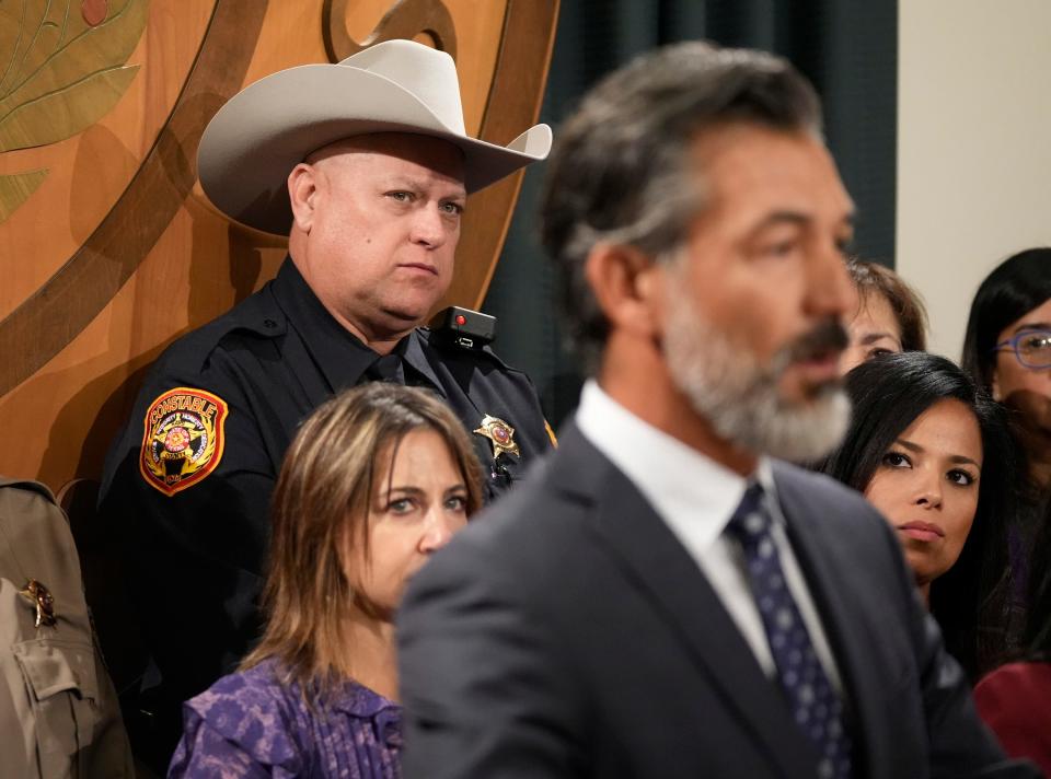Hays County Constable Daniel Law listens as Rep. Ramon Romero Jr., D - Fort Worth, speaks against border bills at a news conference with members of the Mexican American Legislative Caucus at the Capitol on Wednesday October 25, 2023.