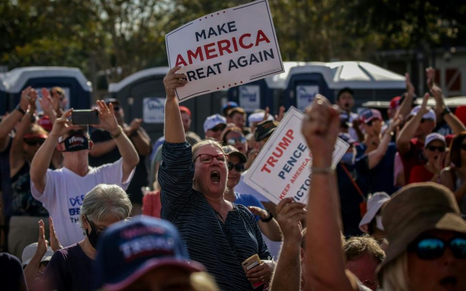 Thousands of unmasked supporters cheer as US Vice President Mike Pence speaks at a rally in The Villages, central Florida - AFP