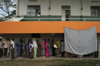 People line up to cast their ballot for Gambia's presidential elections, in Banjul, Gambia, Saturday, Dec. 4, 2021. Lines of voters formed outside polling stations in Gambia’s capital as the nation holds a presidential election. The election on Saturday is the first in decades without former dictator Yahya Jammeh as a candidate. (AP Photo/Leo Correa)