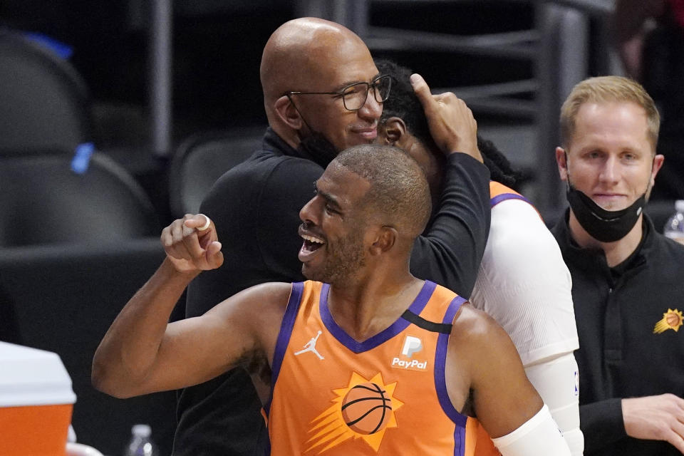 Phoenix Suns head coach Monty Williams, left, hugs Jae Crowder, second from right, while guard Chris Paul celebrates as time runs out in Game 6 of the NBA basketball Western Conference Finals against the Los Angeles Clippers Wednesday, June 30, 2021, in Los Angeles. The Suns won the game 130-103 to take the series 4-2. (AP Photo/Mark J. Terrill)