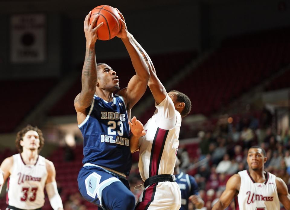 Rhode Island's David Green heads to the hoop against a UMass defender on Sunday afternoon at Mullins Center in Amherst.