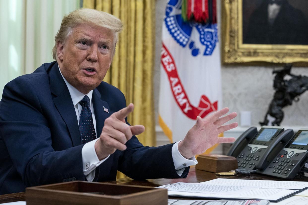 President Donald Trump with Attorney General William Barr, make remarks before signing an executive order in the Oval Office that will punish Facebook, Google and Twitter for the way they police content online: Doug Mills/The New York Times