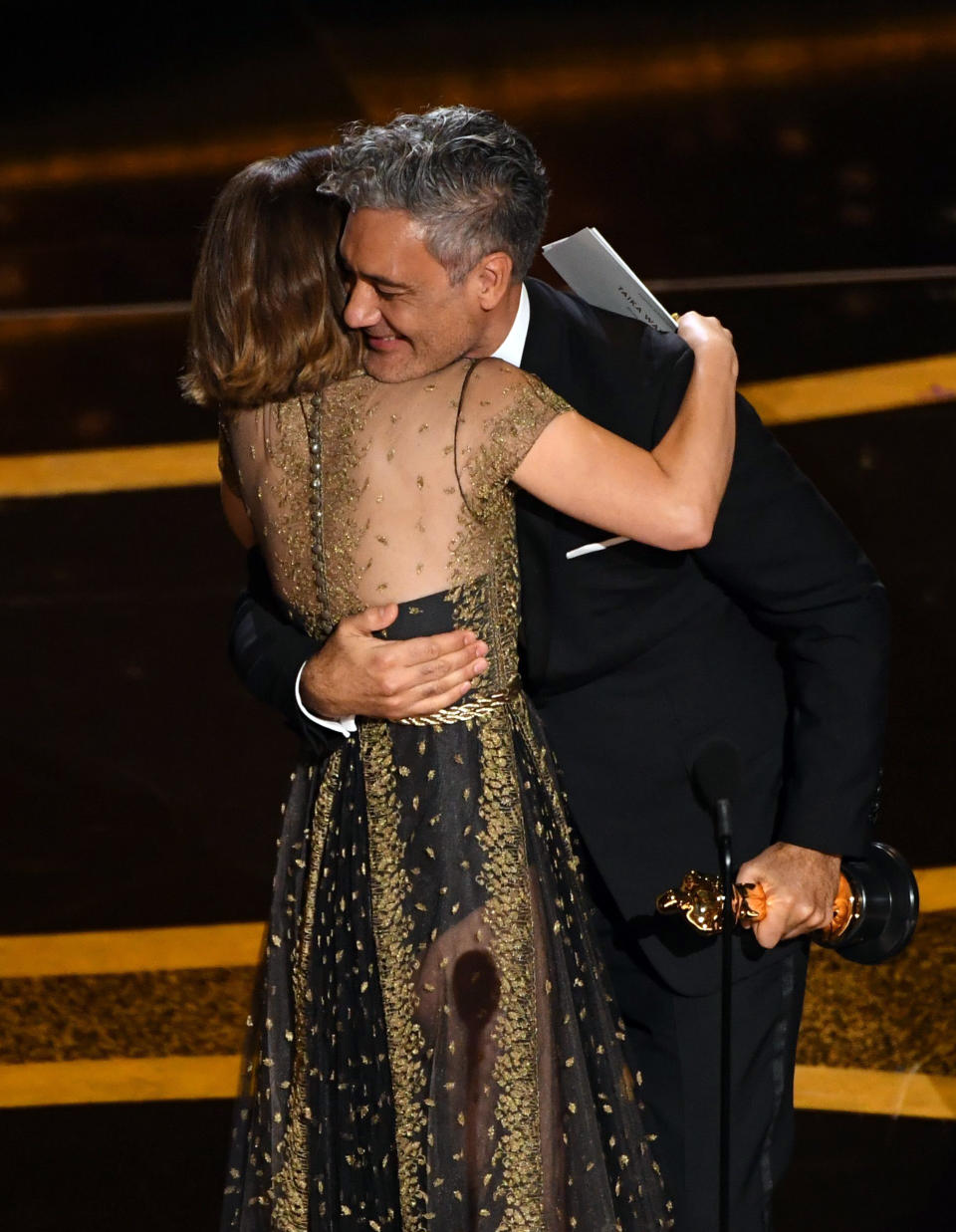 Natalie hugging Taika onstage