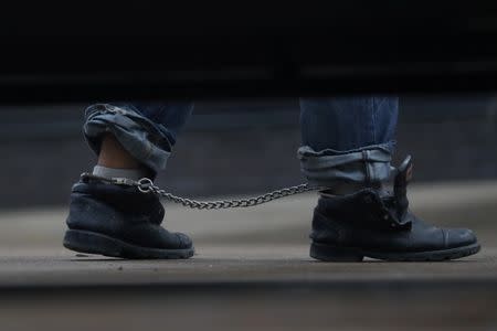 Undocumented immigrants in shackles arrive at a U.S. federal court for hearings in McAllen, Texas, U.S., June 22, 2018. REUTERS/Loren Elliott