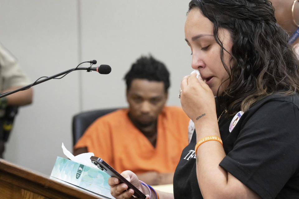 D’Pree Shareef Robinson listens as stepmother Korrina Smith reads letters from Trinity Ottoson-Smith's friends about what her loss means to them Tuesday, July 11, 2023, in Minneapolis. Robinson was sentenced Tuesday to more than 37 years in prison for fatally shooting a 9-year-old Minnesota girl as she was jumping on a trampoline with friends. Robinson pleaded guilty in March to second-degree murder in the 2021 death of Ottoson-Smith. (Glen Stubbe/Star Tribune via AP, Pool)