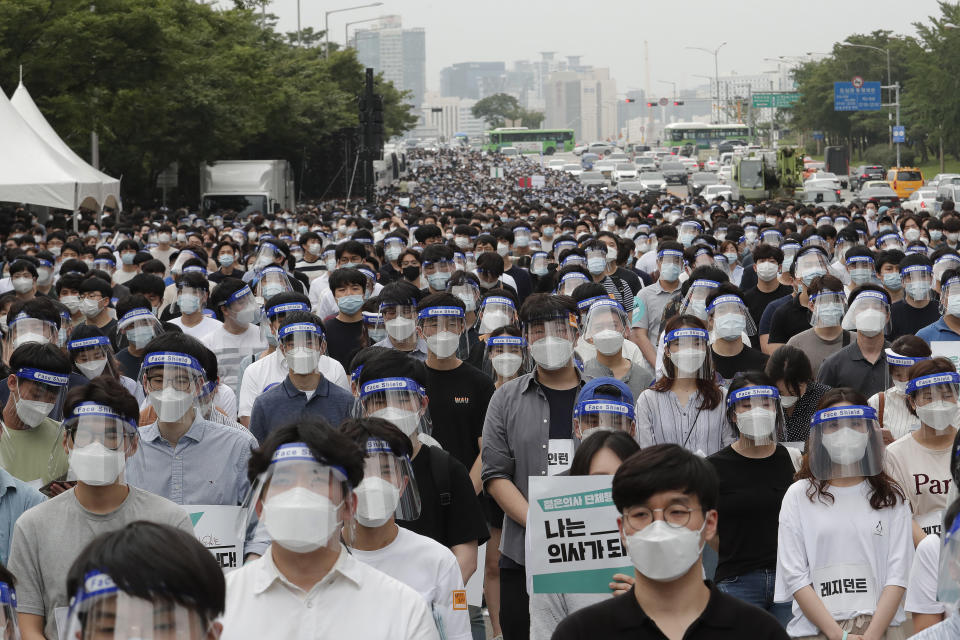 Interns and resident doctors stage a rally against the government medical policy in Seoul, South Korea, Friday, Aug. 7, 2020. Thousands of young doctors in South Korea began a strike Friday in protest of government medical policy, causing concerns about treatment of patients amid the coronavirus pandemic. (AP Photo/Ahn Young-joon)