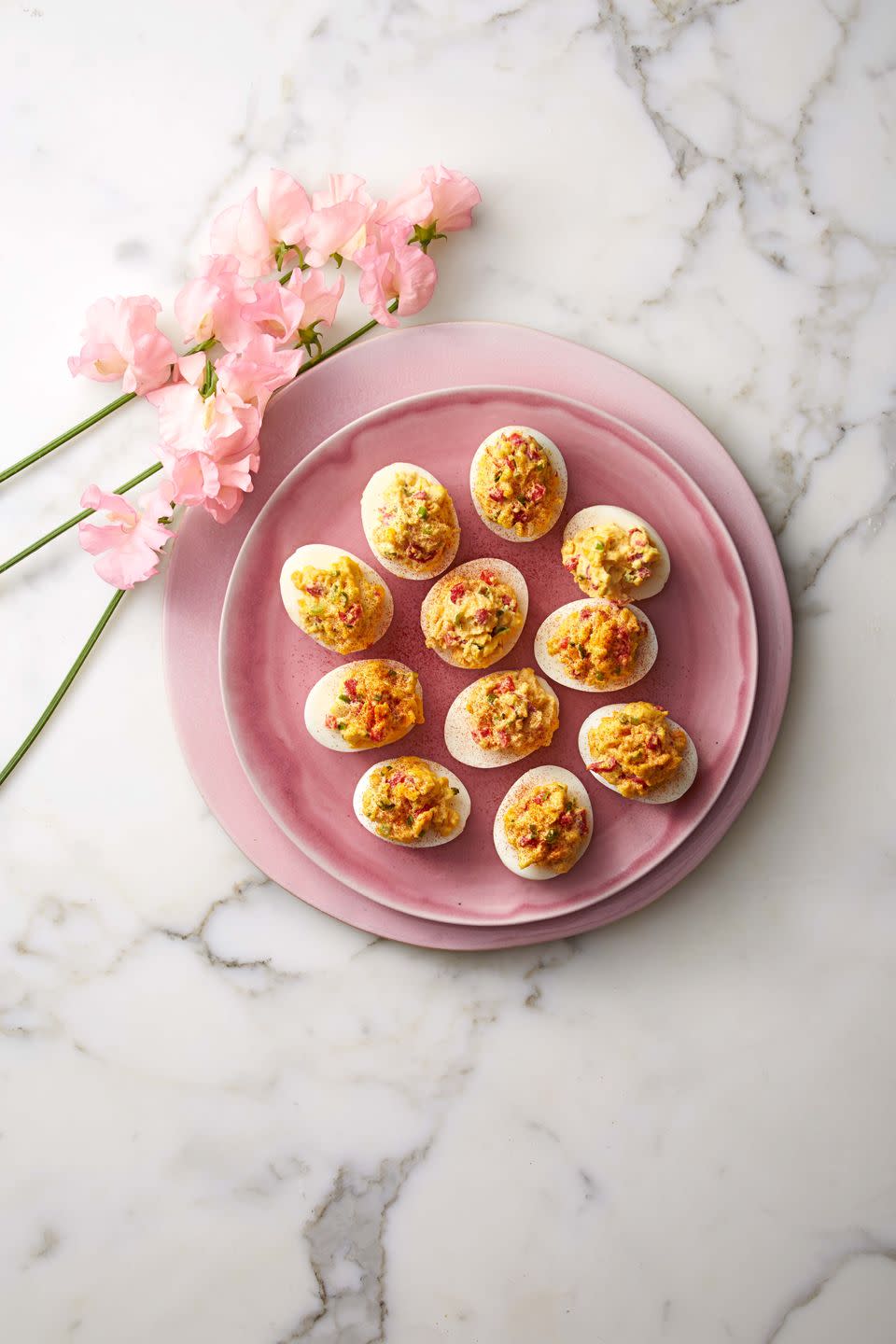 pimiento cheese deviled eggs on a pink plate