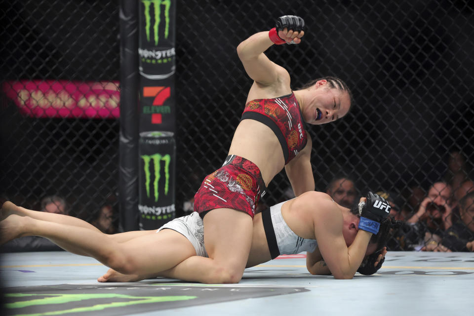 UFC women's strawweight champion Zhang Weili, top, punches Yan Xiaonan in a women's title fight during the UFC 300 mixed martial arts event Saturday, April 13, 2024, in Las Vegas. Zhang retained her title by unanimous decision. (Steve Marcus/Las Vegas Sun via AP)