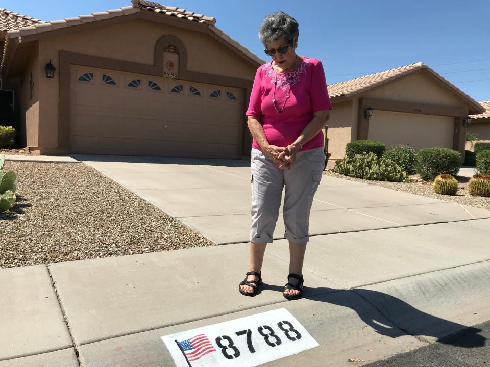 Donna Cordero, 82, of Peoria is fighting her homeowner's association's order to paint over the American flag displayed on her curb.