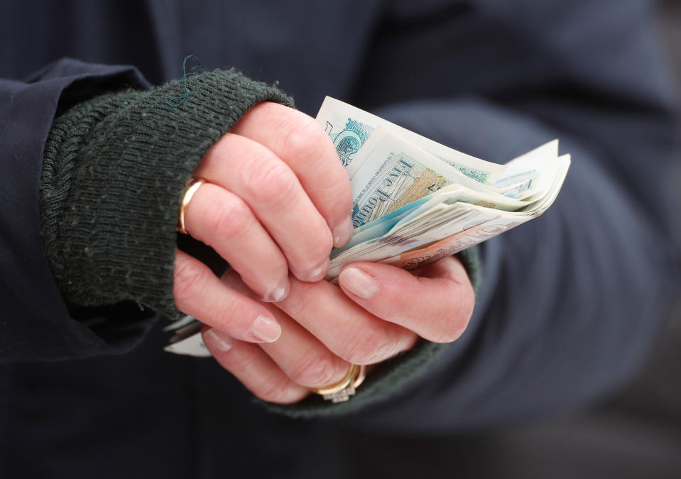 Horse Racing - Cheltenham Festival - Cheltenham Racecourse, Cheltenham, Britain - March 12, 2019   A racegoer holds money at the Cheltenham Festival   Action Images via Reuters/Paul Childs