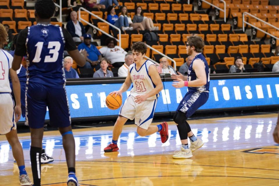 Zsolt Boros dribbles through traffic against Monsignor Donovan Saturday.