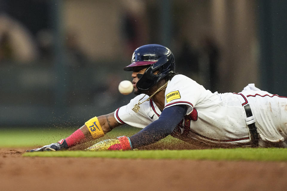 FILE - Atlanta Braves right fielder Ronald Acuna Jr. beats the throw to steal second base in the third inning of a baseball game against the Los Angeles Dodgers, Tuesday, May 23, 2023, in Atlanta. Thanks to several rules changes, runners swiped bags more proficiently and stolen bases across the majors increased 41% from 2,486 in 2022 to 3,503 in 2023. Acuna Jr. led the major with 73 steals. (AP Photo/John Bazemore, File)