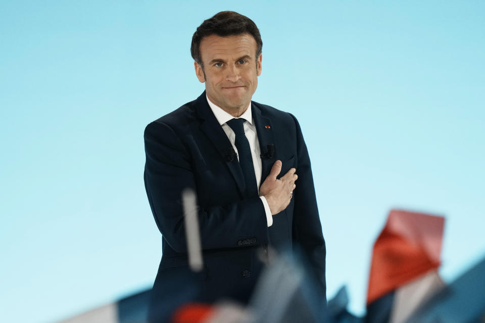 Current French President and centrist presidential candidate for reelection Emmanuel Macron puts his hands on his heart at his election night headquarters Sunday, April 10, 2022 in Paris. (Thibault Camus/AP)