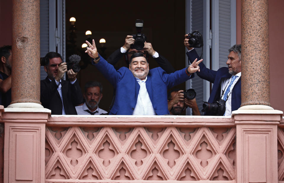 El legendario astro de fútbol hace la señal de victoria en la Casa Rosada en Buenos Aires tras reunirse con el presidente argentino Alberto Fernández el jueves, 26 de diciembre del 2019. (AP Foto/Marcos Brindicci)