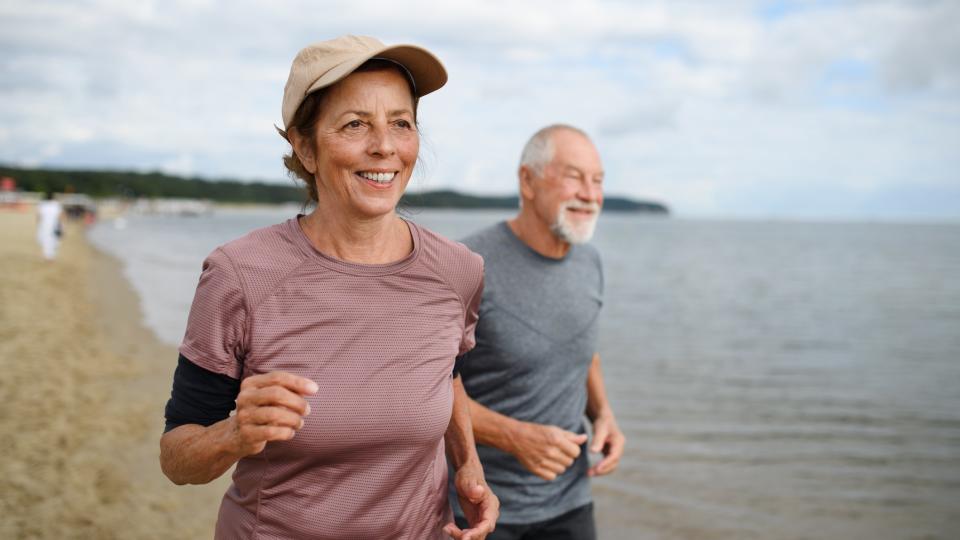 a photo of an older couple running together