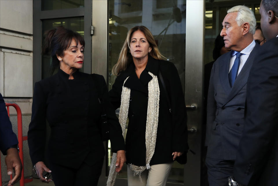 Former campaign adviser for President Donald Trump, Roger Stone, right, leaves federal court Thursday, Feb. 21, 2019, in Washington, with his wife, Nydia Stone and daughter Adria, Stone, center. A judge has imposed a full gag order on Trump confidant Roger Stone after he posted a photo on Instagram of the judge with what appeared to be crosshairs of a gun. (AP Photo/Jacquelyn Martin)