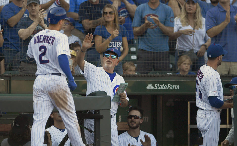 Chicago Cubs' Nico Hoerner (2) celebrates with manager Joe Maddon right, at the dugout after hitting a solo home run during the sixth inning of a baseball game against the Pittsburgh Pirates Saturday, Sept. 14, 2019, in Chicago. Chicago won 14-1. (AP Photo/Paul Beaty)