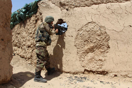 An Afghan National Army (ANA) soldier mans his position at an outpost in Babaji area of Lashkar Gah Helmand province, Afghanistan May 8, 2016. REUTERS/Abdul Malik