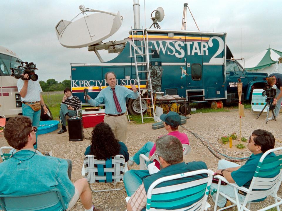Members of the press sit through an Easter Sunday Service in a media encampment near the Branch Davidian compound in 1993.