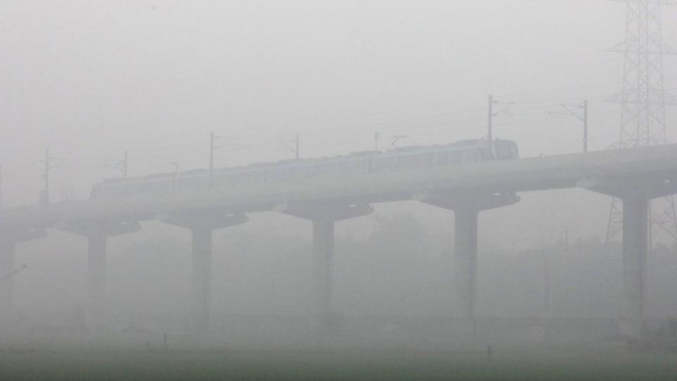 A train moves amid dense fog near Delhi on 30 January