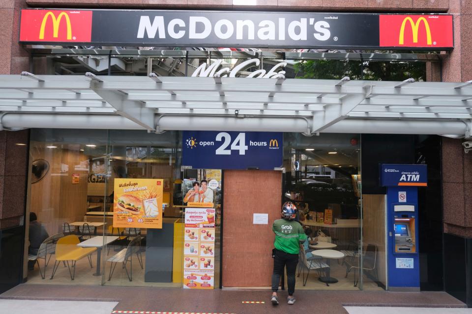 A sign on the door of a McDonald's as a person enters after earlier problems in the fast food restaurant, in Bangkok, Friday, March 15, 2024. System failures at McDonald’s have been reported worldwide, shuttering some restaurants for hours and leading to social media complaints.