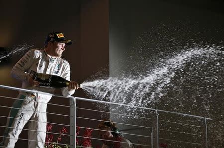 Formula One - F1 - Singapore Grand Prix - Marina Bay, Singapore - 18/9/16. Mercedes' Nico Rosberg of Germany celebrates on the podium after winning the race. REUTERS/Edgar Su