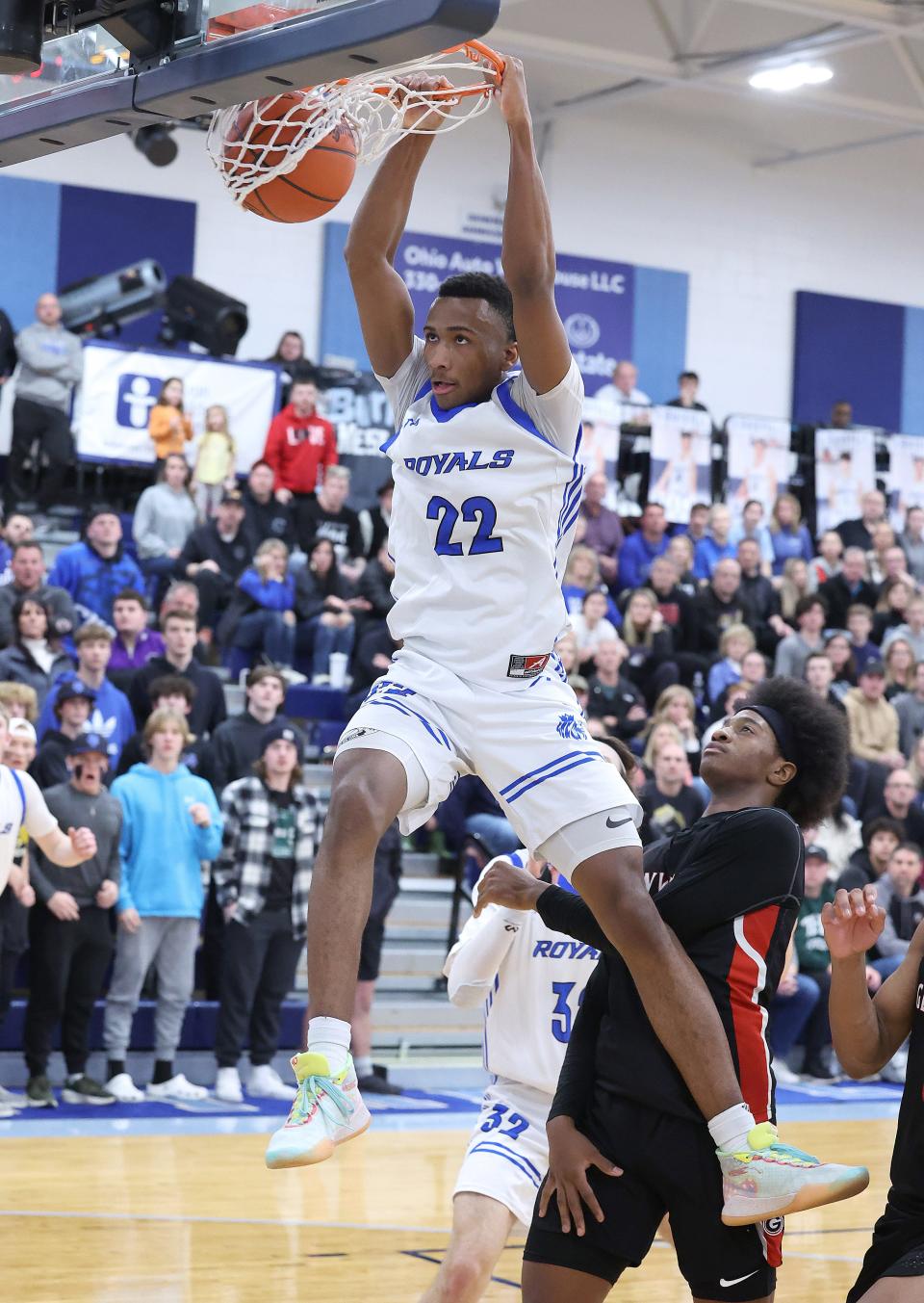 CVCA’s Darryn Peterson slam dunks in the second half with pressure from Glenville’s Damion Witten at Louisville High School Saturday.