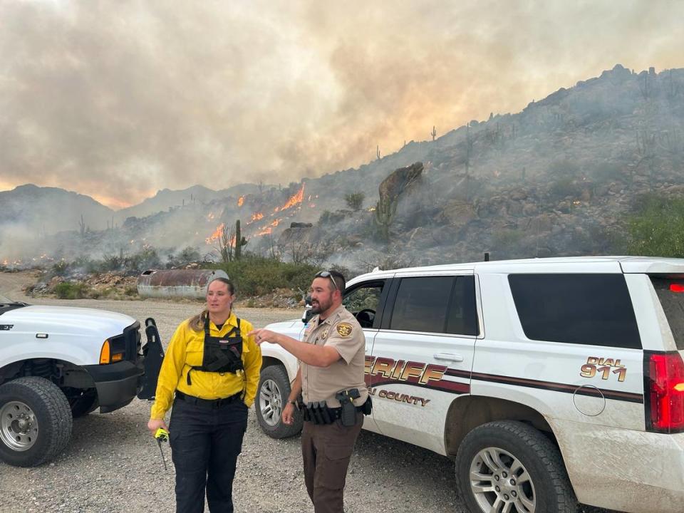 Authorities are pictured near the wildfire in Arizona.