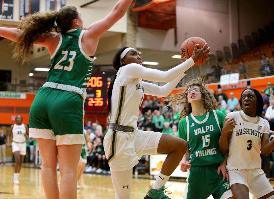 WashingtonÕs Rashunda Jones (2) drives to the basket as teammate Ryiah Wilson (3) looks on and ValparaisoÕs Lillian Barnes (23) and Kristin Bukata (15) defend Saturday, Feb. 11, 2023, at the girls 4A basketball regional game at LaPorte High School. Washington won, 60-41, to advance.