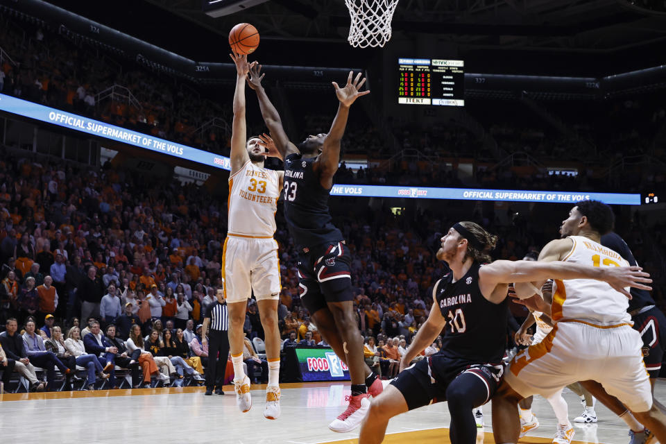 Tennessee forward Uros Plavsic, left, shoots over South Carolina forward Josh Gray during the first half of an NCAA college basketball game Saturday, Feb. 25, 2023, in Knoxville, Tenn. (AP Photo/Wade Payne)