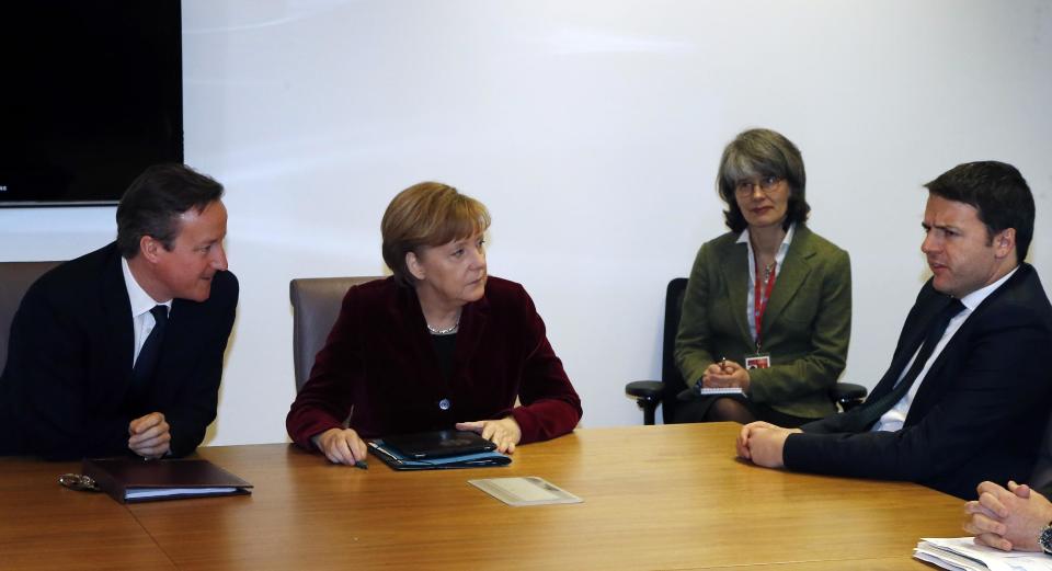 British Prime Minister David Cameron, left, and German Chancellor Angela Merkel, second left, speak with Italian Prime Minister Matteo Renzi, right, during a meeting at an EU summit in Brussels on Thursday, March 6, 2014. EU heads of state meet Thursday in emergency session to discuss the situation in Ukraine. (AP Photo/Michel Euler, Pool)