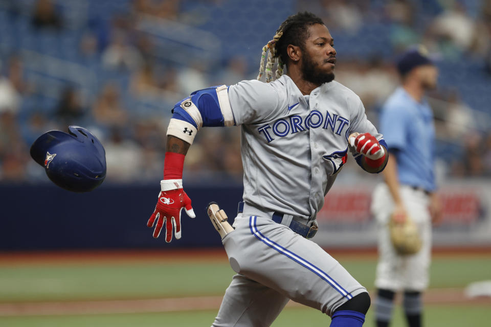 Toronto Blue Jays' Raimel Tapia loses his helmet running to first against the Tampa Bay Rays during the third inning of a baseball game Sunday, Sept. 25, 2022, in St. Petersburg, Fla. (AP Photo/Scott Audette)