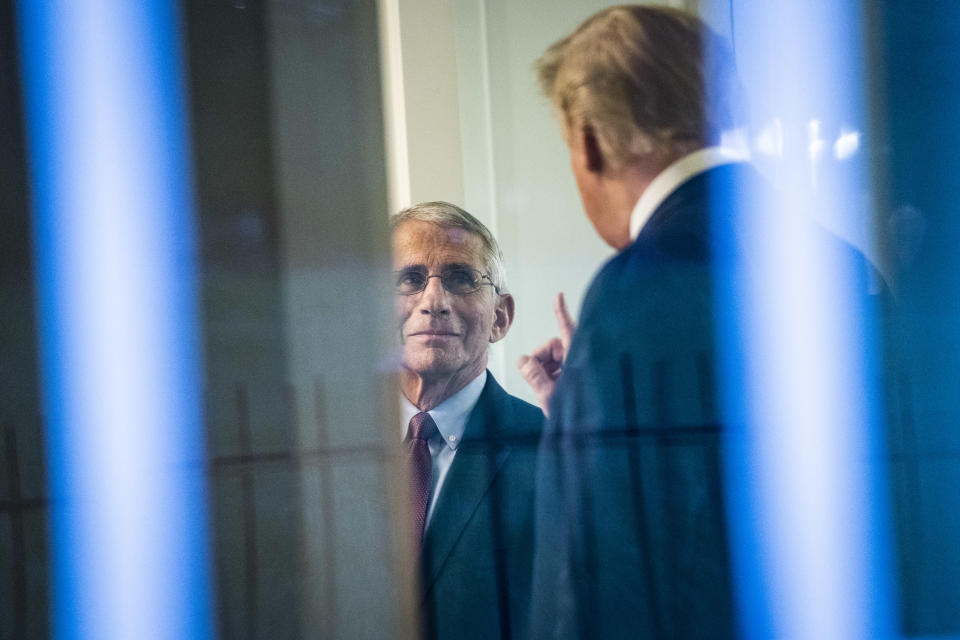 Trump speaks with Fauci after a briefing with members of the coronavirus task force at the White House.