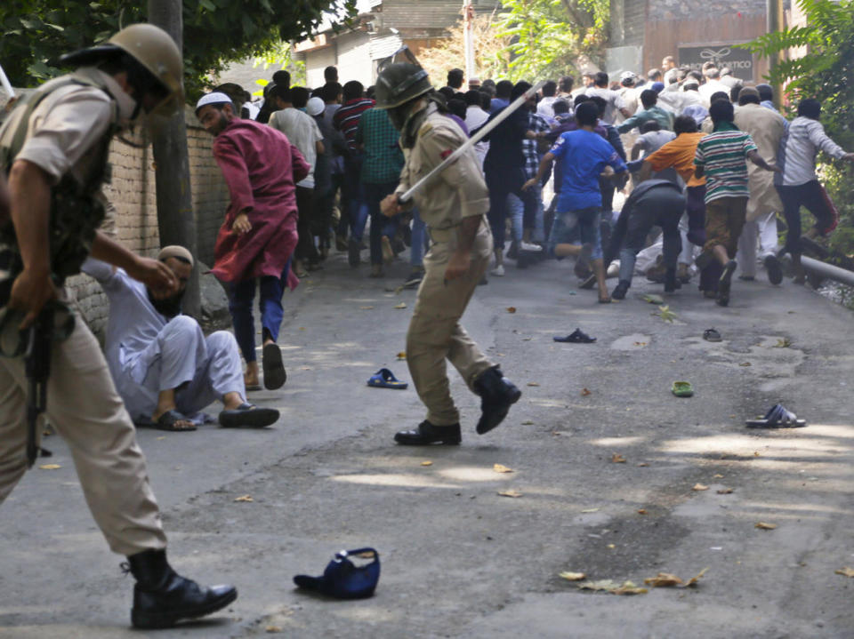 <p>Indian policemen charge at protestors outside the office of the United Nations Military Observer Group in Srinagar, Indian controlled Kashmir, July 29, 2016. Police fired tear gas and used wooden batons to disperse the protesters. However, youths regrouped in streets later and clashed with the police, hurling rocks at them. (Photo: Mukhtar Khan/AP)</p>