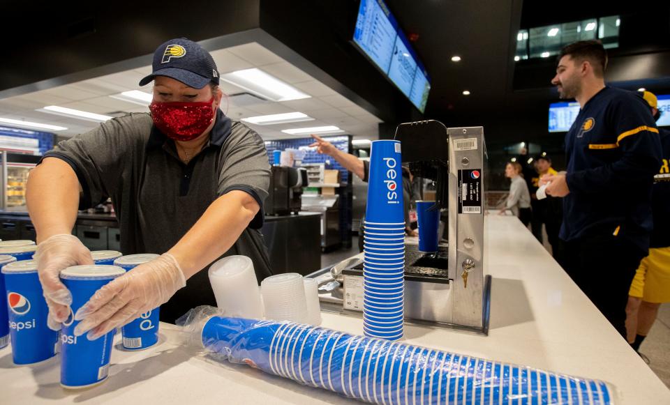 Jamie Richmond prepares sodas at a renovated concession stand Friday, Dec. 3, 2021 at Gainbridge Fieldhouse in Indianapolis.