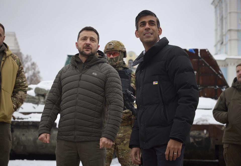 In this photo provided by the Ukrainian Presidential Press Office, Ukrainian President Volodymyr Zelenskyy, left, and British Prime Minister Rishi Sunak observe destroyed Russian military vehicles installed in downtown Kyiv, Ukraine, Saturday, Nov. 19, 2022. (Ukrainian Presidential Press Office via AP)