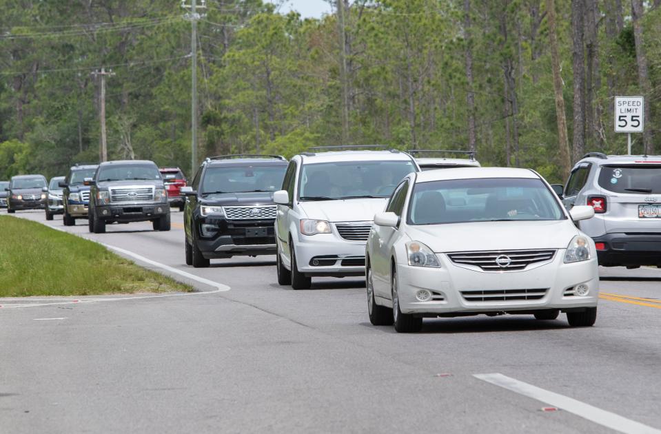 Traffic drives along Sorrento Road between Gulf Beach Highway and Blue Angels Parkway in Escambia County on April 20.