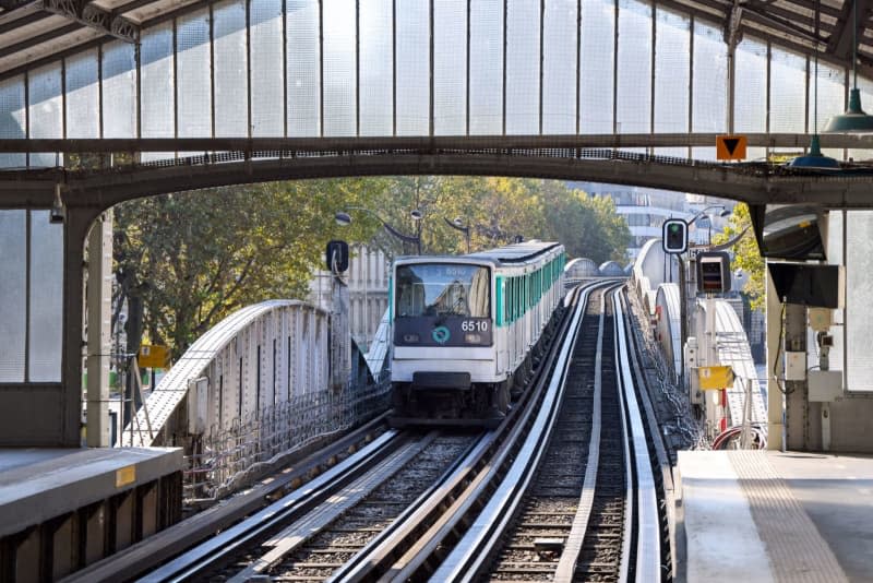 A Paris Metro train leaves the 'Dupleix' station. Paris plans to charge visitors significantly higher prices for the metro during the Olympic Games next year. Public transport is a key issue for host cities and LA officials are already creating - and cancelling - transit plans. Jan Woitas/ZB/dpa