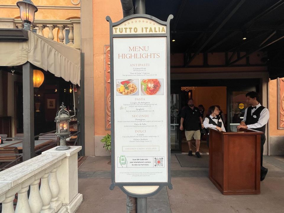 standing white menu outside of  tutto italia