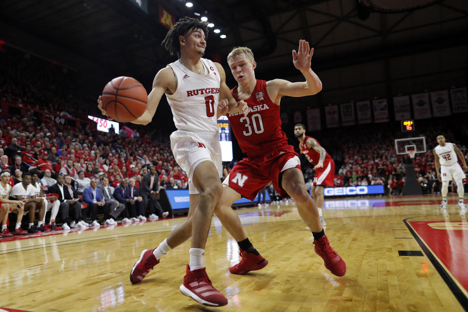 Rutgers guard Geo Baker (0) looks to pass around Nebraska guard Charlie Easley (30) during the second half of an NCAA college basketball game Saturday, Jan. 25, 2020, in Piscataway, N.J. Rutgers won 75-72. (AP Photo/Adam Hunger)