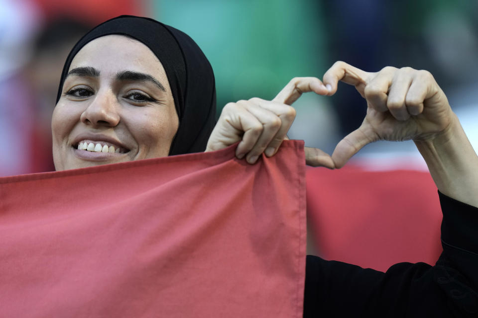 A soccer supporter shows a heart formed by fingers before the World Cup group D soccer match between Denmark and Tunisia, at the Education City Stadium in Al Rayyan , Qatar, Tuesday, Nov. 22, 2022. (AP Photo/Hassan Ammar)