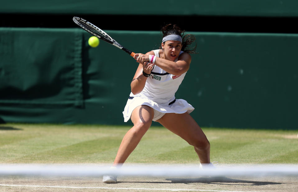 France's Marion Bartoli in action against Germany's Sabine Lisicki during day twelve of the Wimbledon Championships at The All England Lawn Tennis and Croquet Club, Wimbledon.