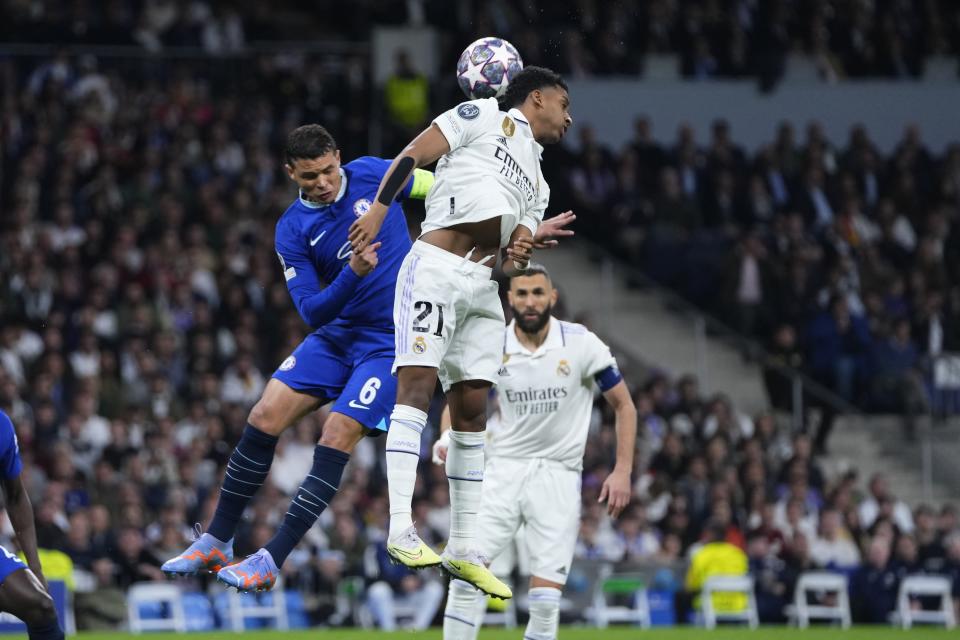 Real Madrid's Rodrygo, right, and Chelsea's Thiago Silva jump for the ball during the Champions League quarterfinal, first leg, soccer match between Real Madrid and Chelsea at the Santiago Bernabeu stadium in Madrid, Spain, Wednesday, April 12, 2023. (AP Photo/Manu Fernandez)